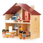 An open-faced wooden dollhouse by Mentari with a red roof and natural wood frame, arranged with miniature wooden furniture, a toy dog, and several wooden character figurines standing outside the rooms.