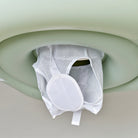 White mesh product hanging from a green plastic holder against a light background