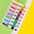 Set of colorful markers on a green and yellow background