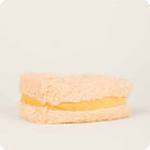 Plush toy resembling a sandwich with beige bread and yellow filling on a light gray background