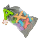 Colorful letter-shaped toys in a gray drawstring bag on a white background