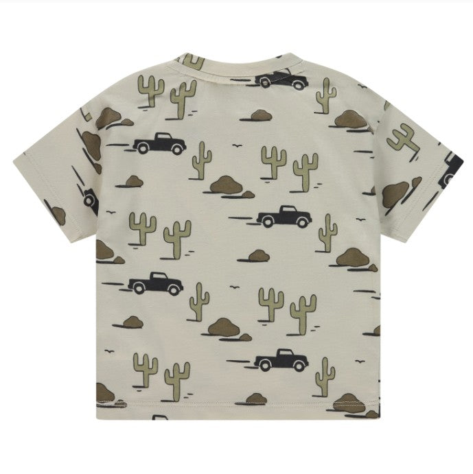 Children's t-shirt with desert-themed pattern featuring cacti and trucks on a beige background