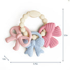 Baby teething ring with pink and blue designs on a white background