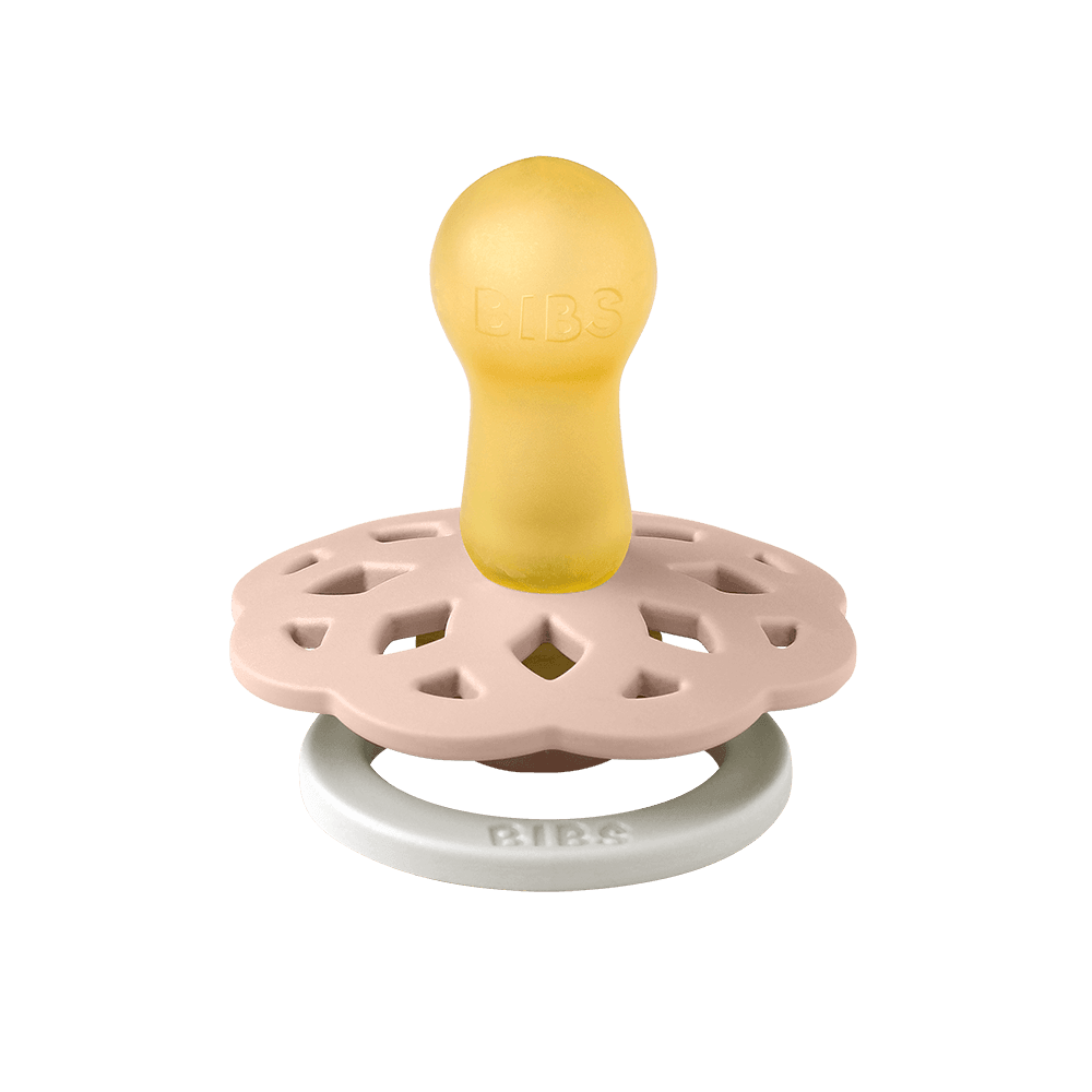 Baby teether with yellow top, pink middle, and white base on a teal background