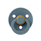 Gray pacifier with a gold center on a dark blue background