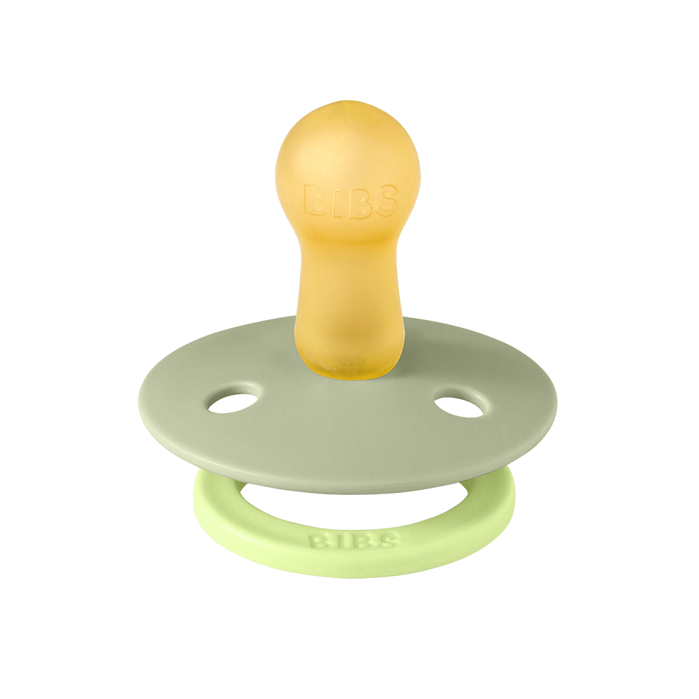 Yellow and green pacifier on a white background