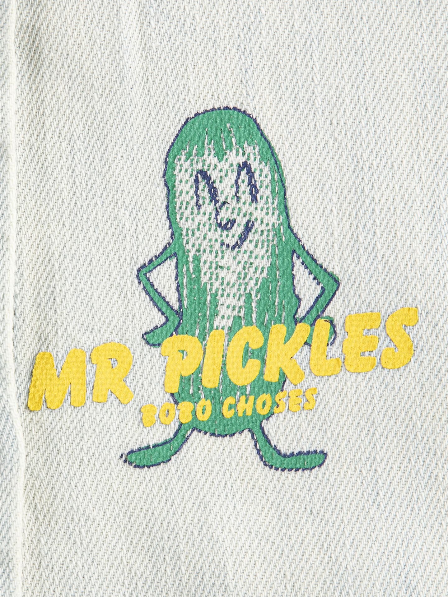 Embroidered design of a pickle with text on a light gray background
