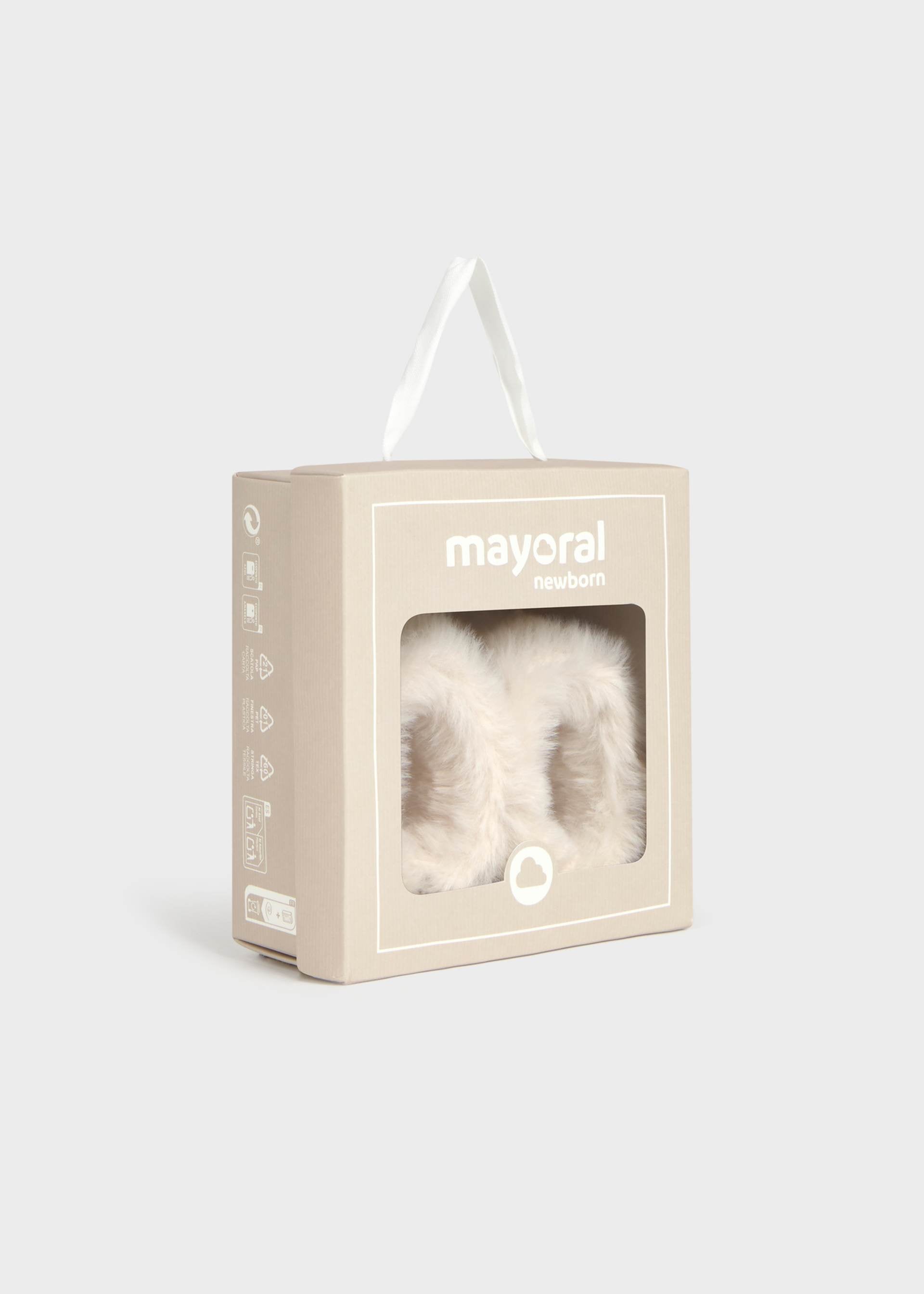 Mayoral Newborn baby booties in a beige presentation box with a clear window showing the fluffy booties inside, set against a light gray background.