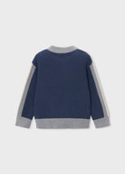 A navy blue ribbed knit sweater with light gray ribbed trim on the collar, cuffs, and hem, featuring light gray and off-white sleeve panels, shown from the back on a light gray background.