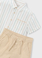 Striped shirt and beige pants on a white background