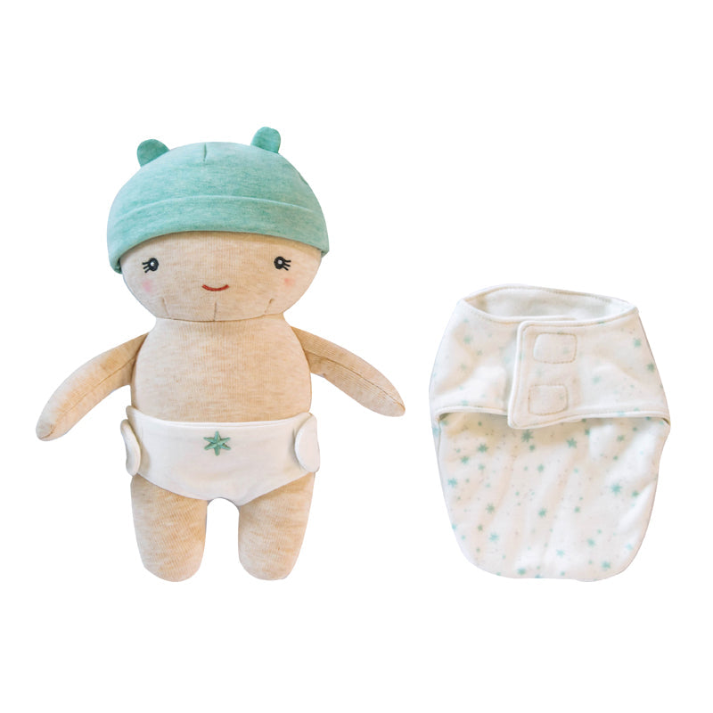 Stuffed toy with a green hat and white diaper next to a baby wrap on a white background