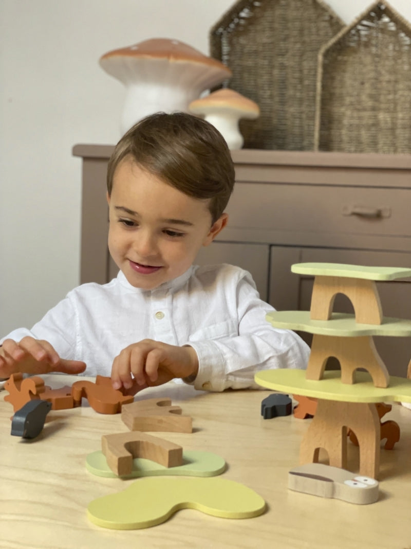Child playing with wooden toys on a table