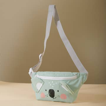 Light green crossbody bag with a koala design on a beige background