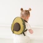 Child wearing a green backpack with a brown patch on a white background