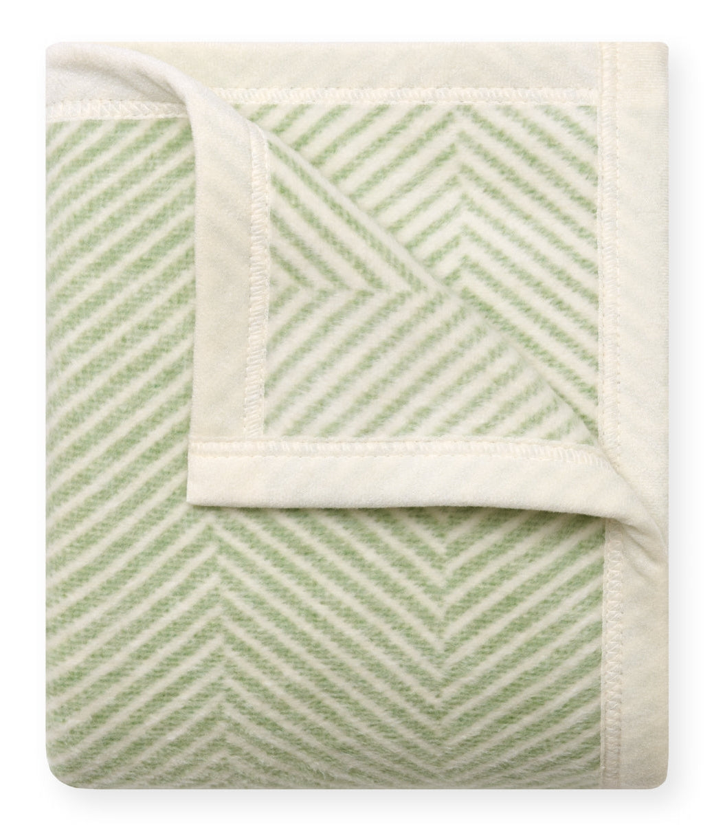 Close-up of a green and white herringbone patterned fabric.
