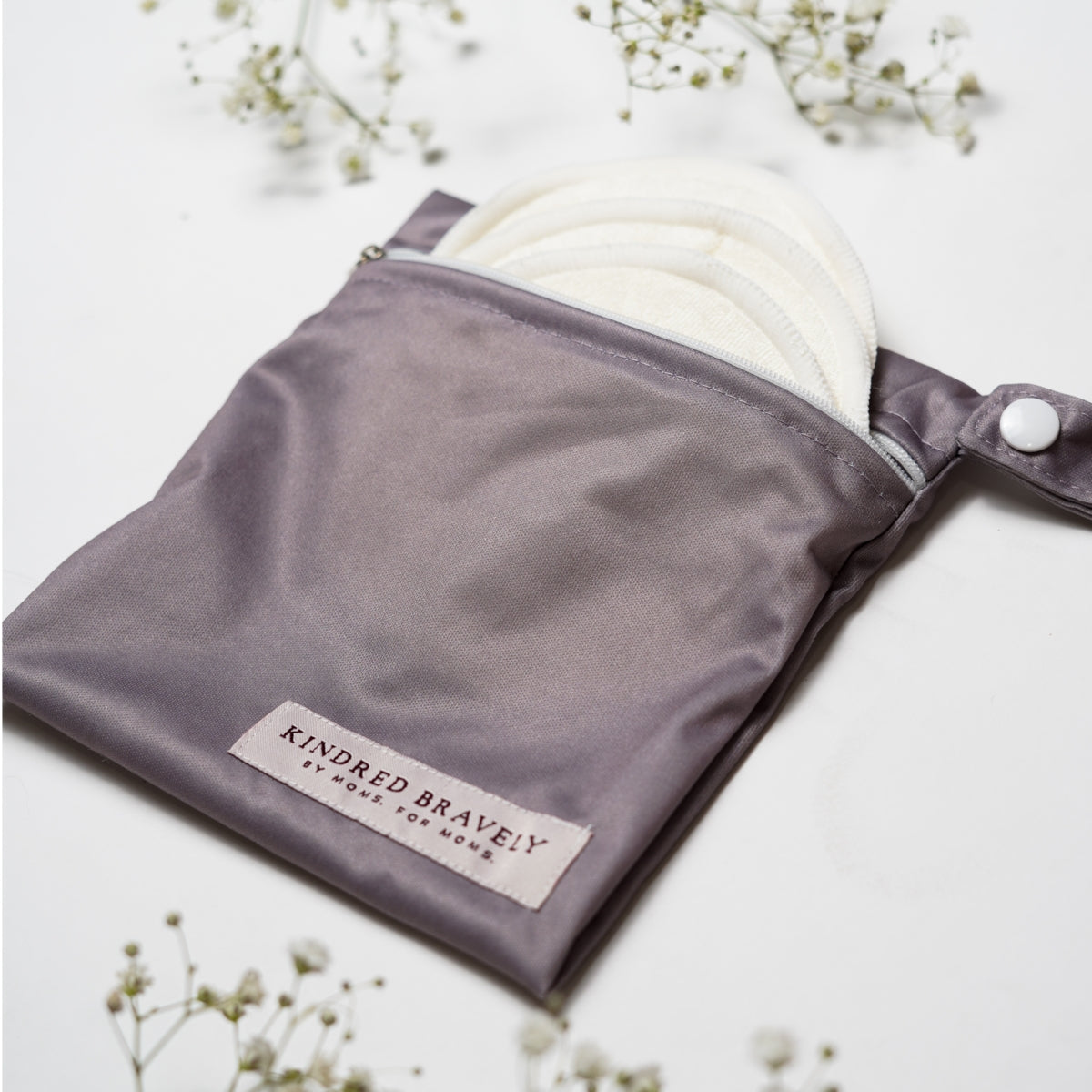 Gray pouch with white product inside on a light background, featuring 'Kindred Brave' branding.