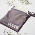 Gray pouch with white product inside on a light background, featuring 'Kindred Brave' branding.