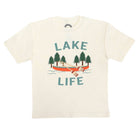 An off-white short-sleeve crewneck t-shirt featuring a graphic print of a red-orange canoe with a person rowing, surrounded by green pine trees and the words 'LAKE LIFE' in teal.
