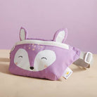 Purple fox-themed pouch with a visible brand tag on a beige surface and purple background
