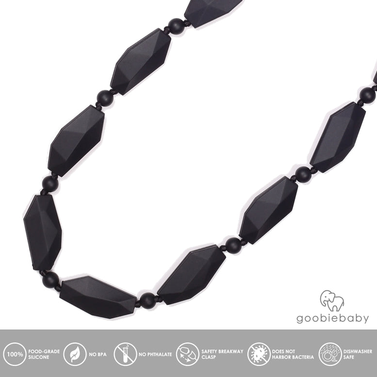 A black beaded necklace with elongated faceted beads and small spacer beads on a thin cord, shown against a plain white background.