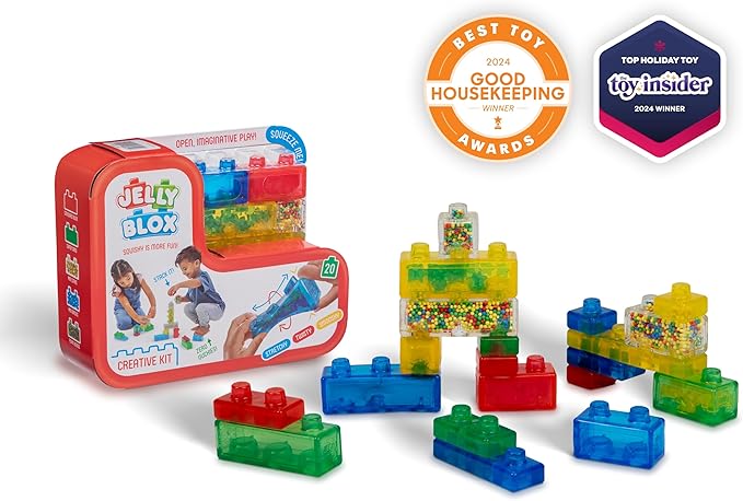 Product photo of the Jelly Blox Creative Kit by Continuum Games showing its red packaging box alongside various colorful, translucent squishy building blocks, feature awards from Good Housekeeping and Toy Insider in the background.