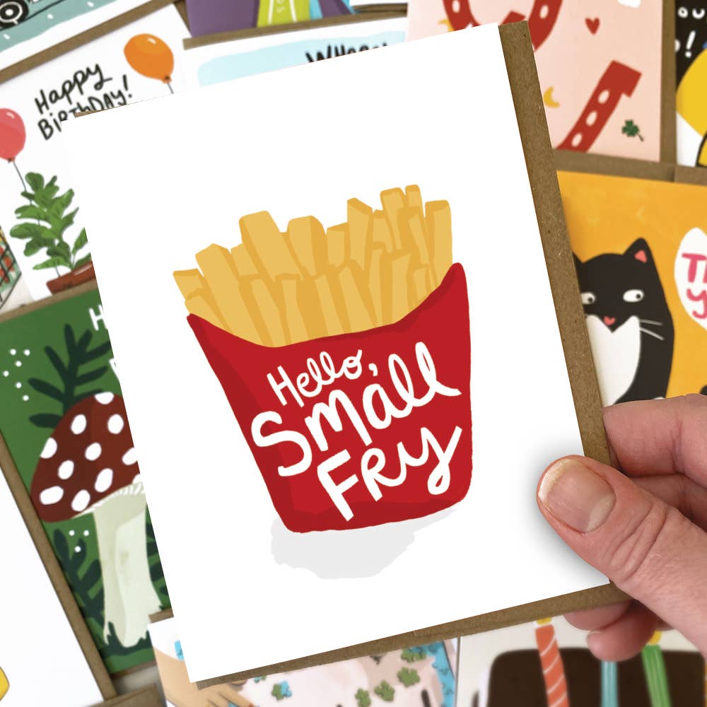 Card with a red container of fries and 'Hello Small Fry' text, held by a hand among other cards.