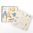 Wooden puzzle set with garden-themed pieces and 'Mary's Garden' packaging on a white background