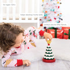 Child playing with a Christmas-themed toy in a festive setting