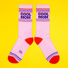 Pink socks with 'Cool Mom' text on a yellow background