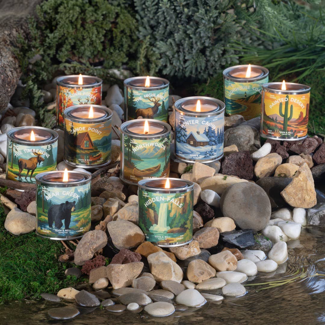 Candle holders with nature-themed designs on a stone surface