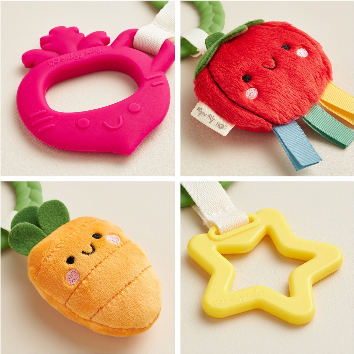 Four colorful baby teething toys shaped like a pineapple, strawberry, orange, and star on a light background.