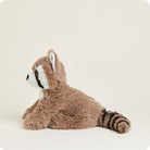 A side-profile studio product photo of a plush Raccoon by Warmies lying down against a white background, highlighting its soft brown fur, white-trimmed ear, and striped tail.
