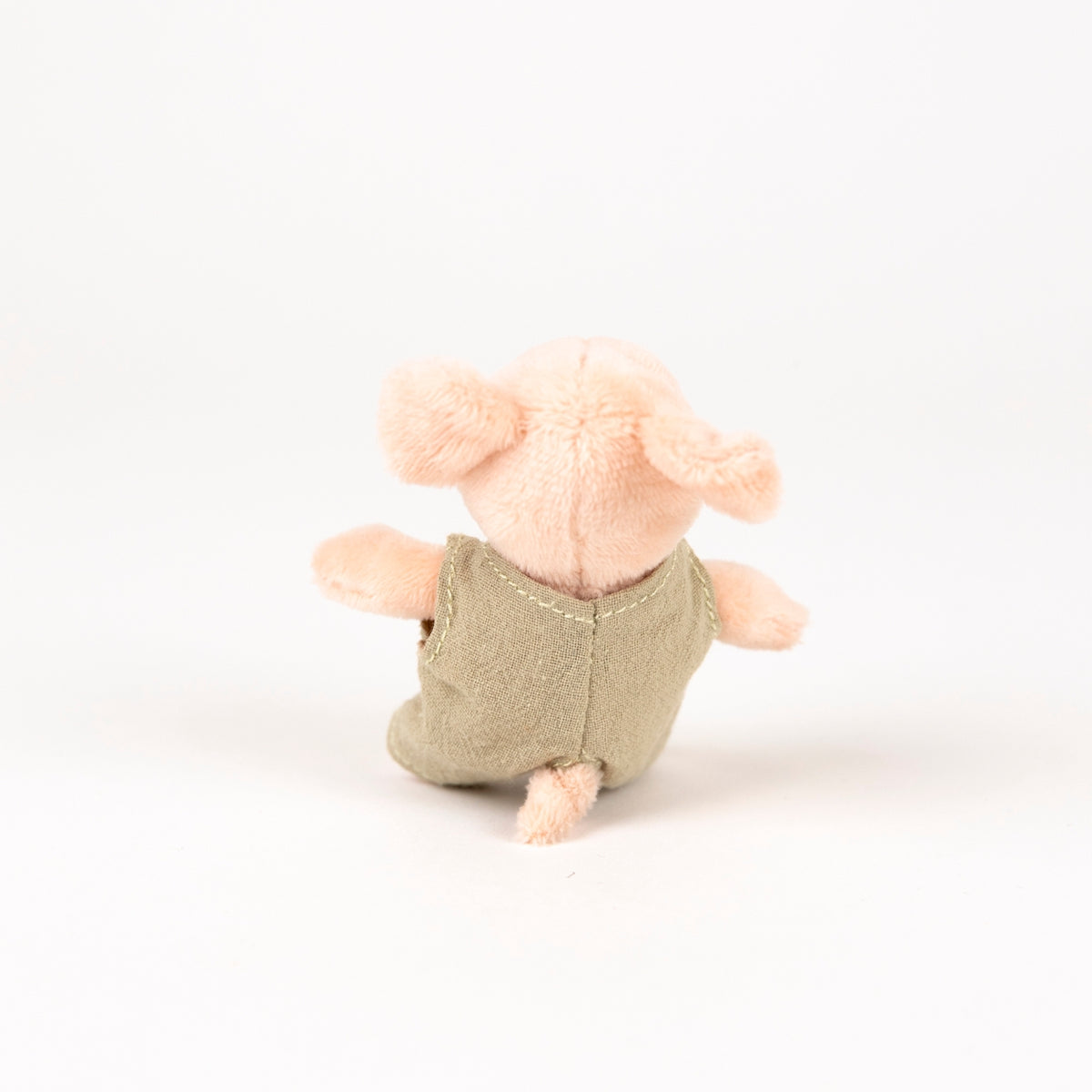 plush pink pig with beige romper - view from the back