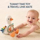 Baby playing with a toy duck on a textured surface, with text 'Tummy Time Toy & Travel Link Mate' above.