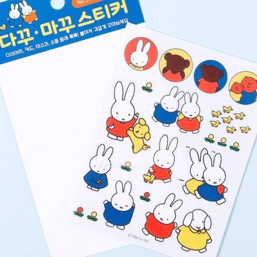 Sheet of cartoon rabbit stickers with colorful clothing on a light blue background.
