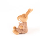 Knitted sweater on a brown bunny toy on a white background