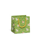 Green gift bag with dog pattern and yellow handle on a white background