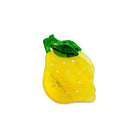 Yellow glass pineapple with green leaves on a white background