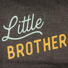 Text 'Little Brother' on a dark fabric background