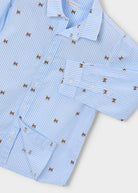 A light blue and white striped long-sleeve button-up shirt with a repeating embroidered bow pattern, shown in a close-up flat-lay view on a light gray background.