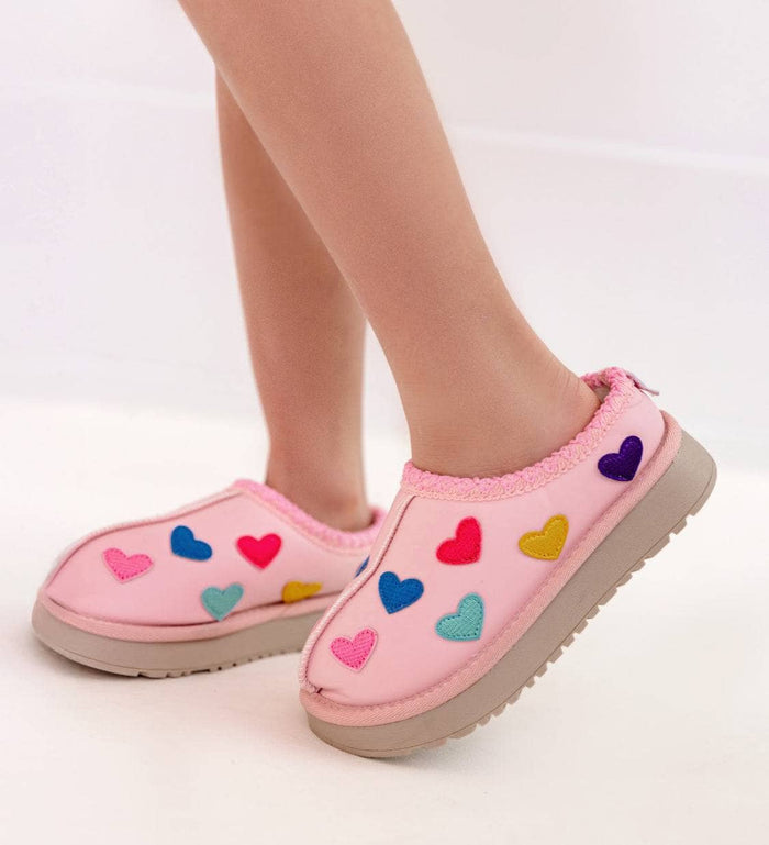 Pink children's shoes with colorful heart patterns on a white background