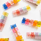Colorful gummy bear-shaped hair clips on a white background