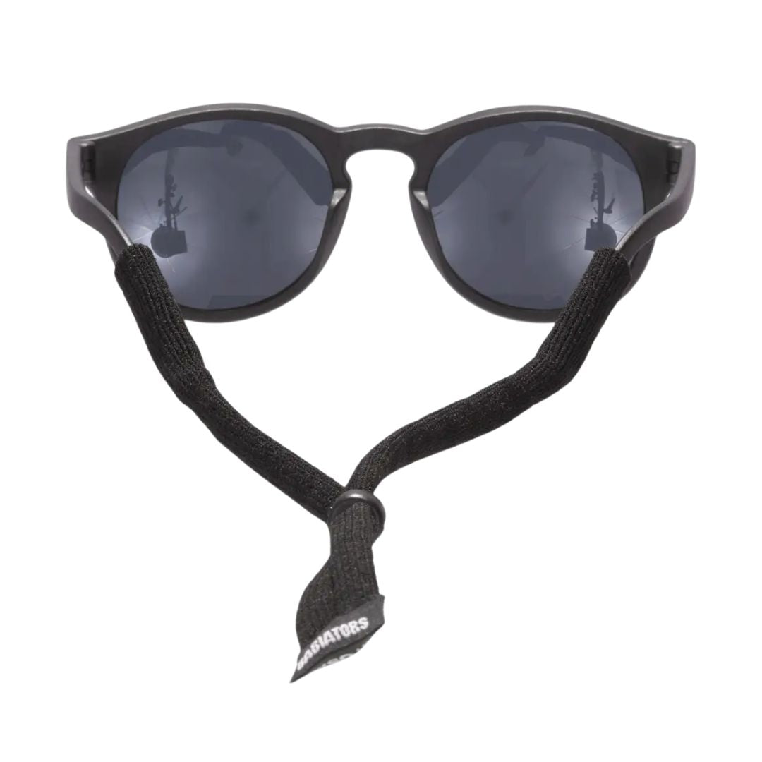 Black sunglasses with a matching black elastic chin strap featuring the brand name 'SUNSHINERS' in white text, shown against a plain white background.