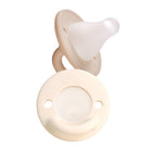 Two beige baby pacifiers on a white background