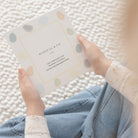 Person holding a product with 'Mindful & Co' branding on a textured surface