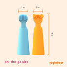 Two children's toothbrushes, one blue and one orange with a bear design, shown with measurements on a beige background.