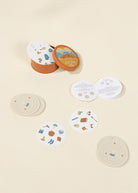Set of circular coasters with illustrations on a beige background
