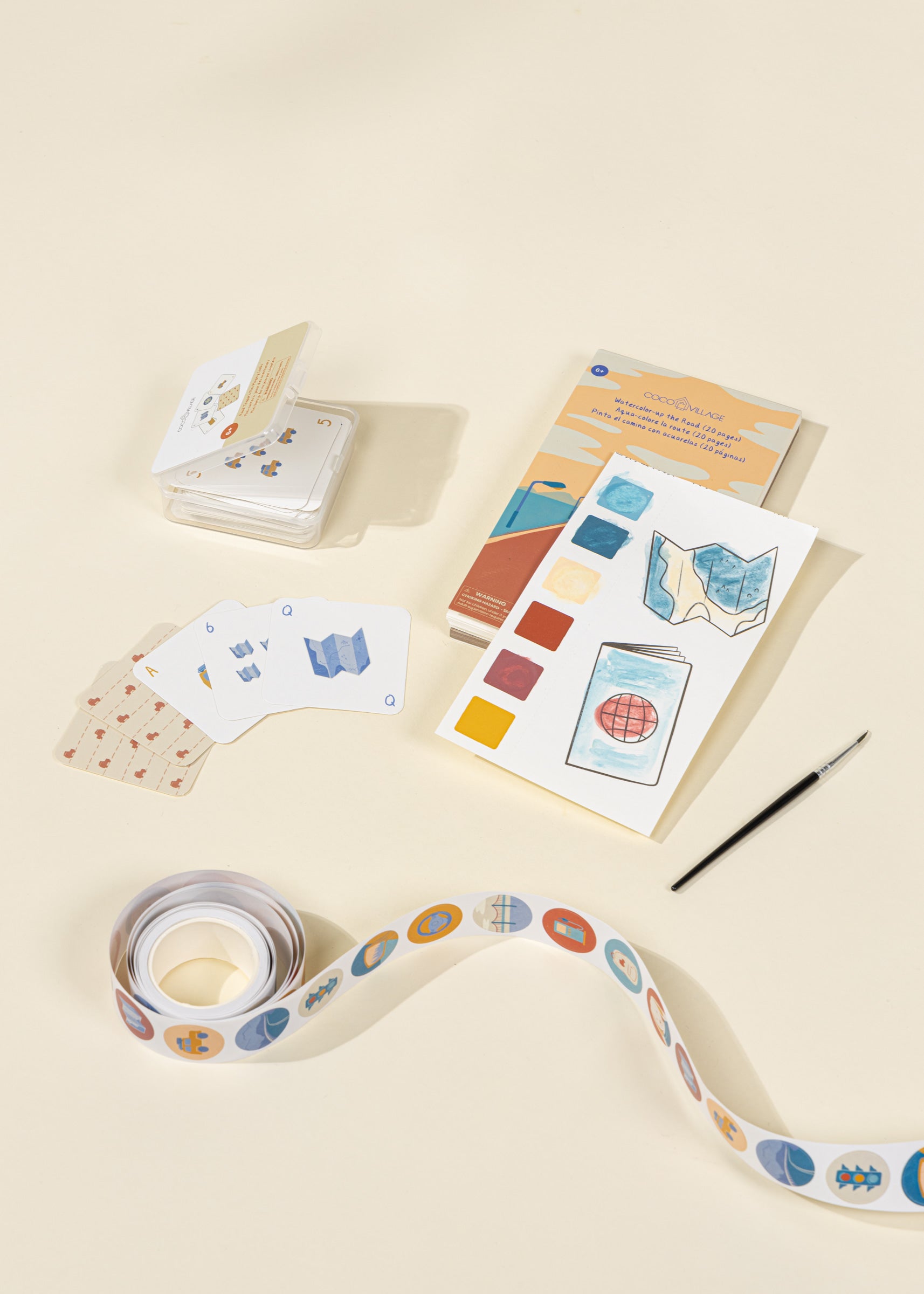 Color swatch book, cards, and ribbon on a beige background
