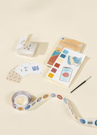 Color swatch book, cards, and ribbon on a beige background