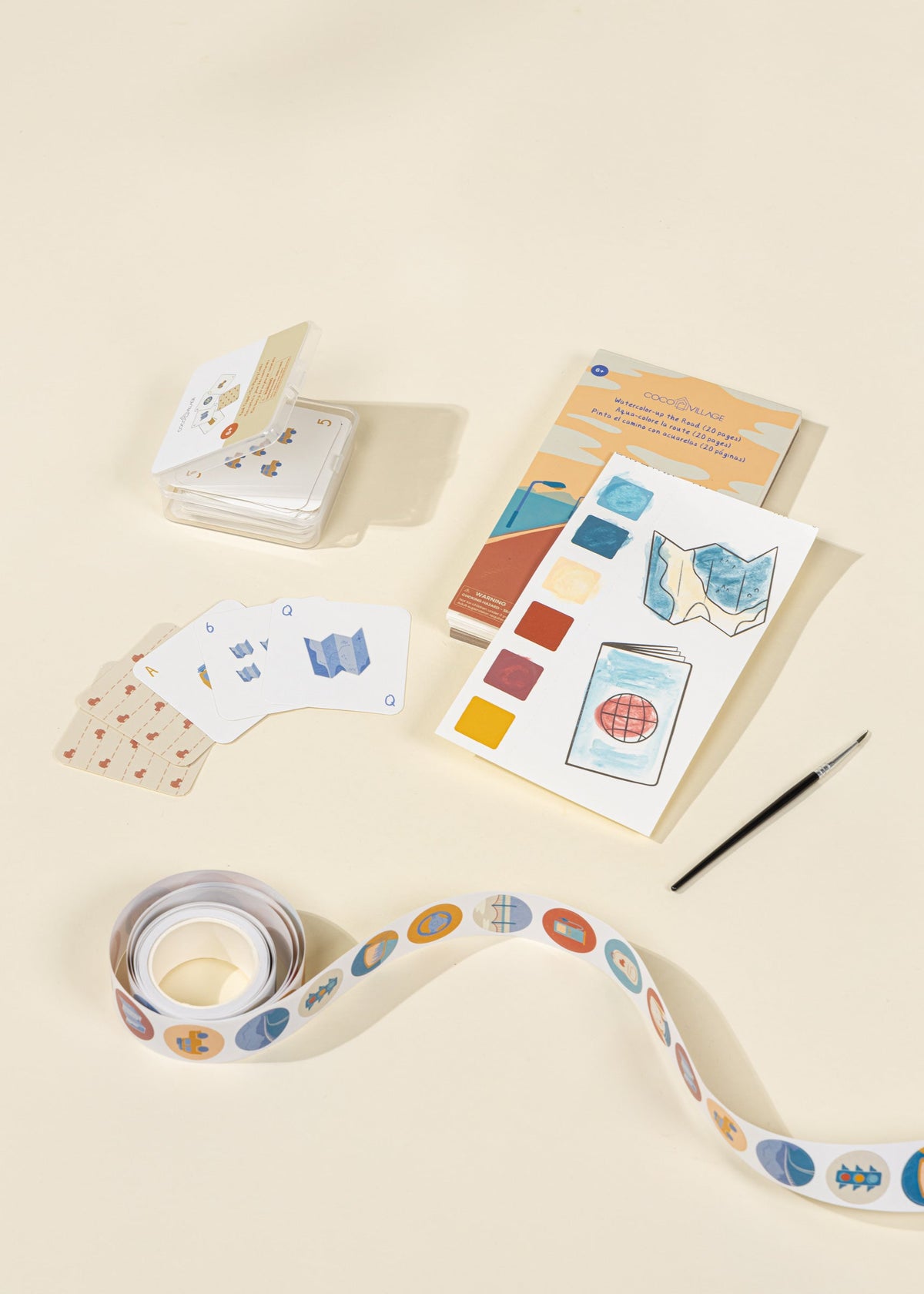 Color swatch book, cards, and ribbon on a beige background